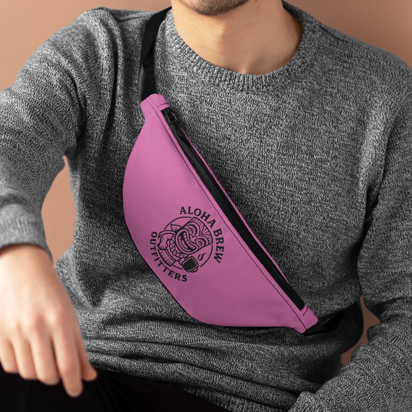 Person wearing a pink sling bag with 'Aloha Brew Outfitters' logo.