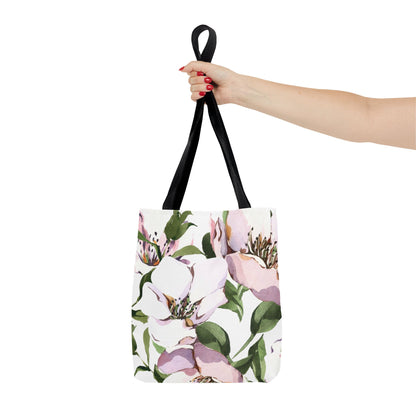 Tote bag with floral design held by a hand on a white background