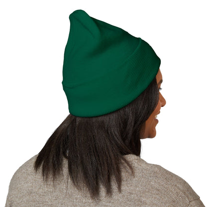 Person wearing a green beanie on a white background
