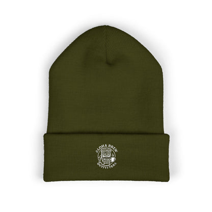 Green beanie with a logo on a white background