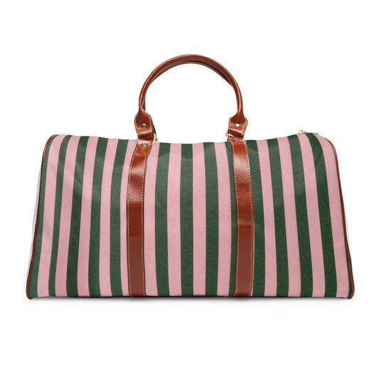 Striped waterproof travel duffle bag with brown leather handles front view