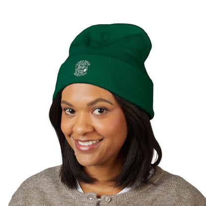 Person wearing a green beanie with a logo on a white background