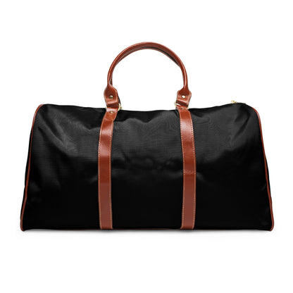 Black duffel bag with brown leather straps on a white background