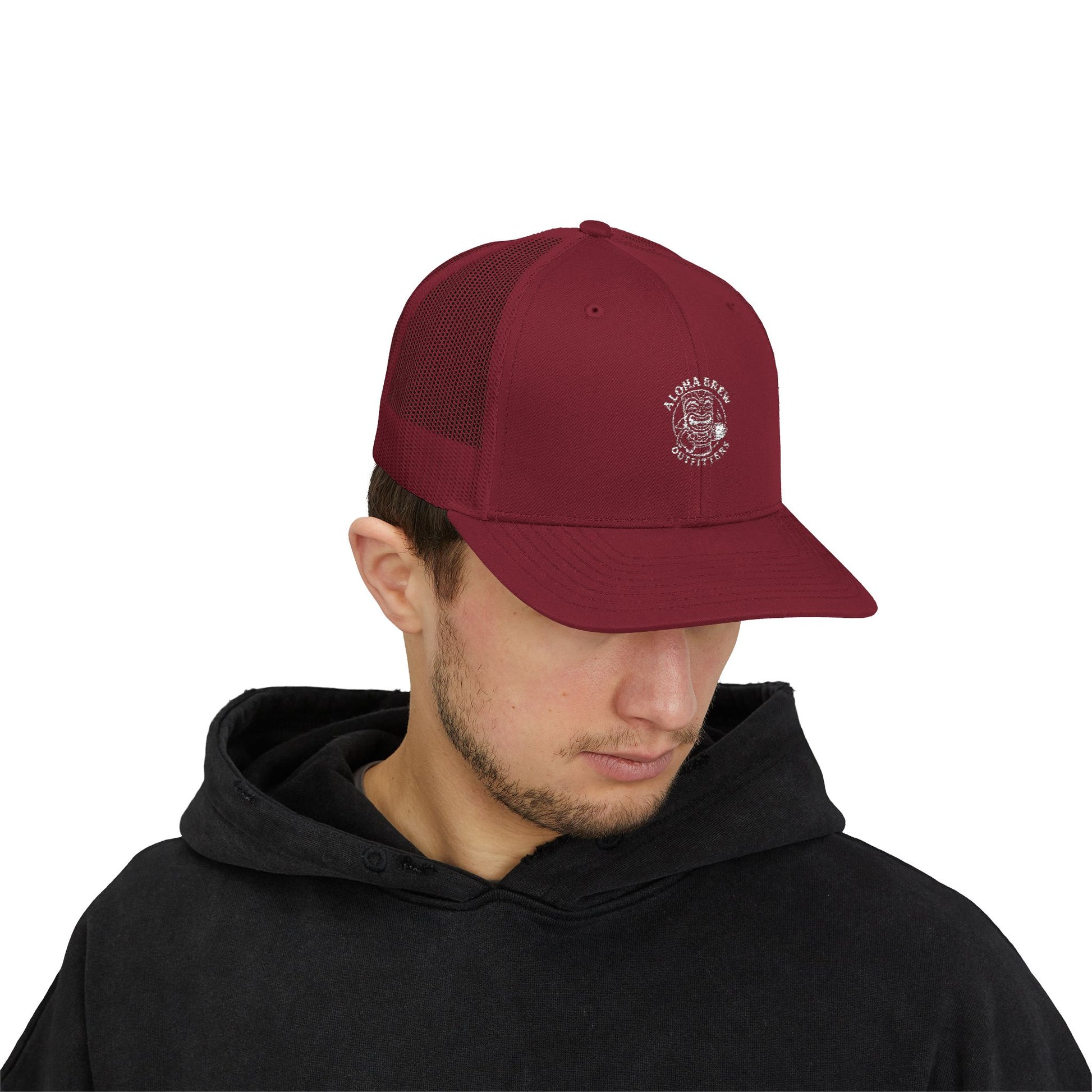 Man wearing a maroon trucker cap with a logo on a white background