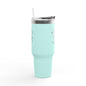 Mint green tumbler with a straw on a white background